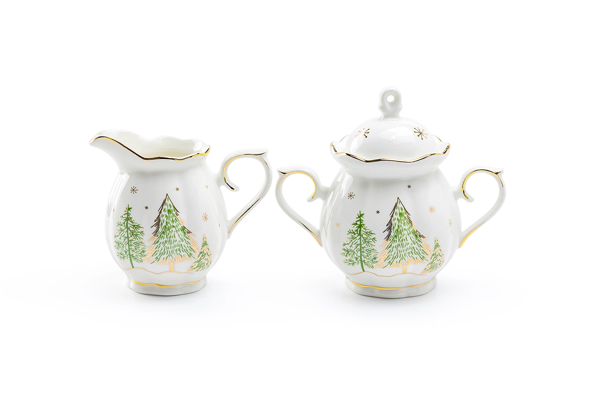 Two ceramic creamer and sugar sets with Christmas tree design on a white background
