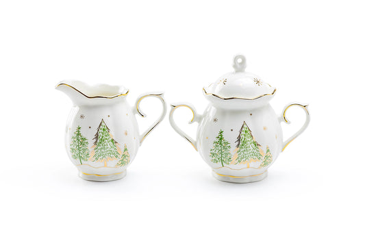 Two ceramic creamer and sugar sets with Christmas tree design on a white background