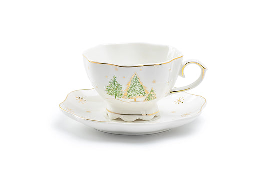 Teacup and saucer with Christmas tree design on a white background