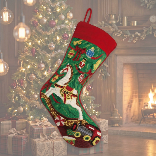 Handcrafted Christmas rocking horse wool needlepoint stocking with traditional holiday toys, green background, and red velvet cuff.