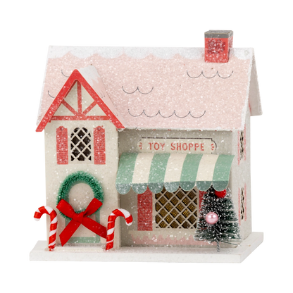Decorative toy shoppe with candy canes and a Christmas tree on a white background