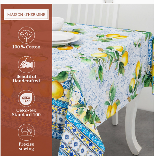 Tablecloth with lemon design on a table, featuring branding and product details.