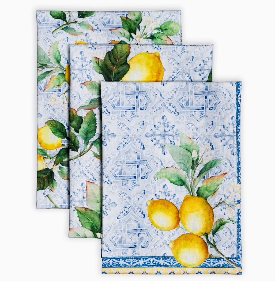 Set of three decorative towels with lemon and tile pattern on a white background