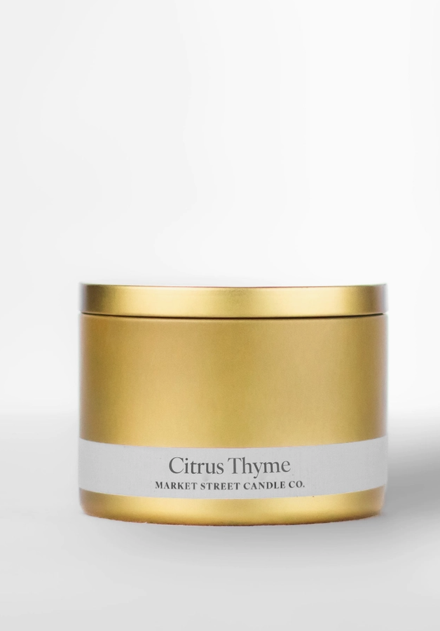 Citrus Thyme Travel Tin soy candle in sleek gold metal tin with white Market Street Candle Co. label.