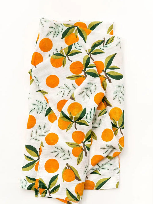 Fabric with orange and leaf pattern on a white background