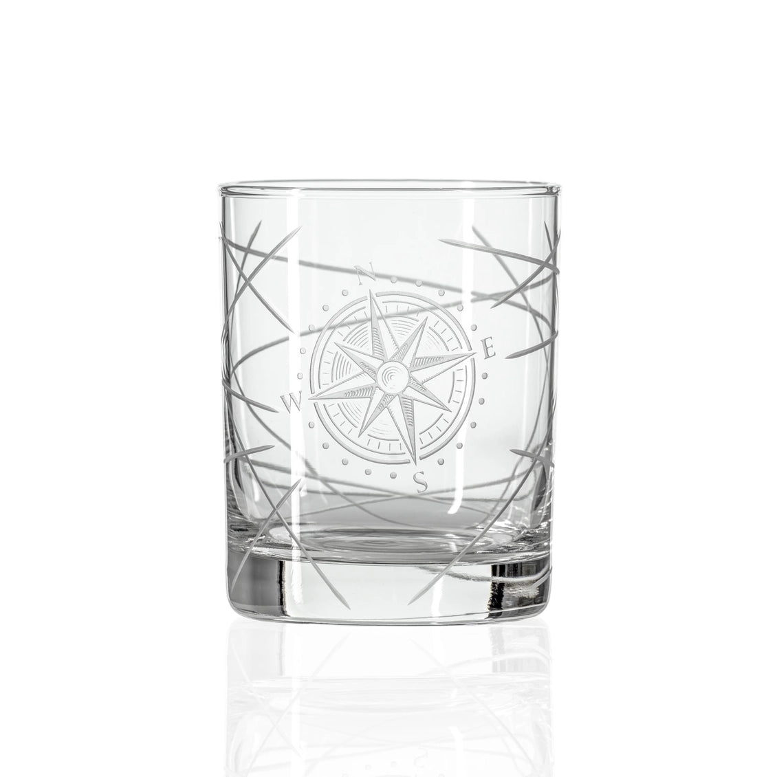 Clear glass tumbler with compass design on a white background