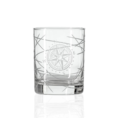 Clear glass tumbler with compass design on a white background