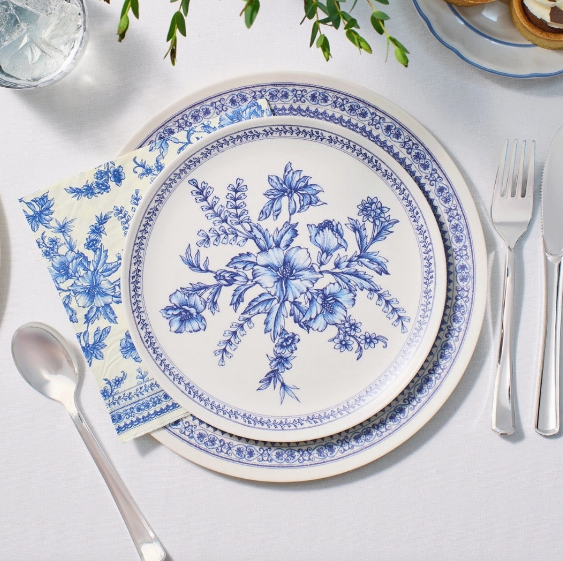 Coterie Blue Toile bamboo dinner and small plates styled with coordinating floral napkin and silver flatware