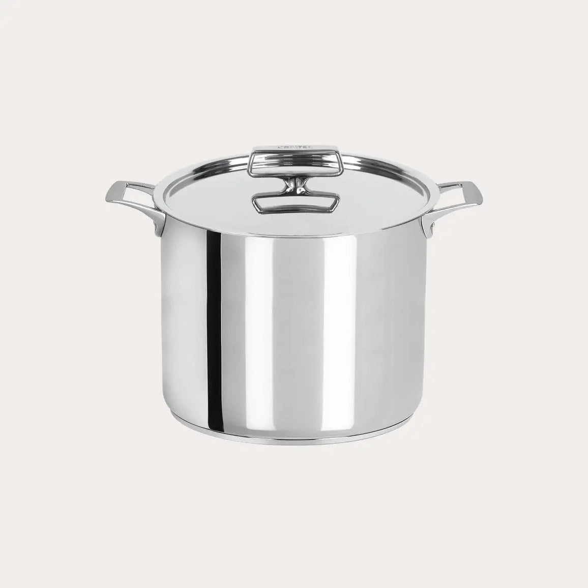 Stainless steel stock pot on a light gray background