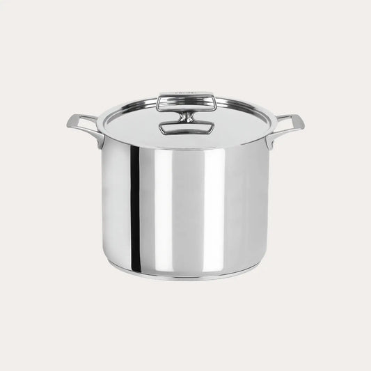 Stainless steel stock pot on a light gray background
