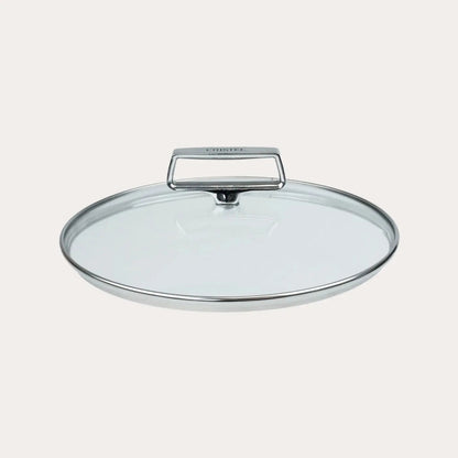 Clear glass lid with a handle on a light gray background