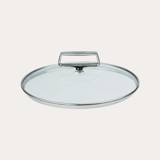 Clear glass lid with a handle on a light gray background