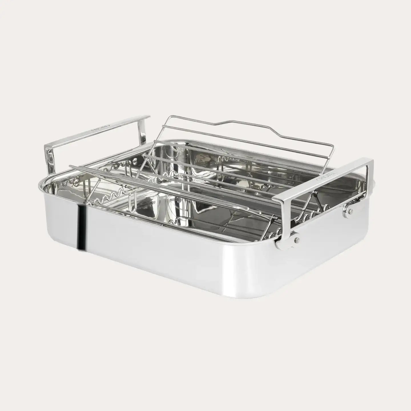 Stainless steel roasting pan with rack on a white background