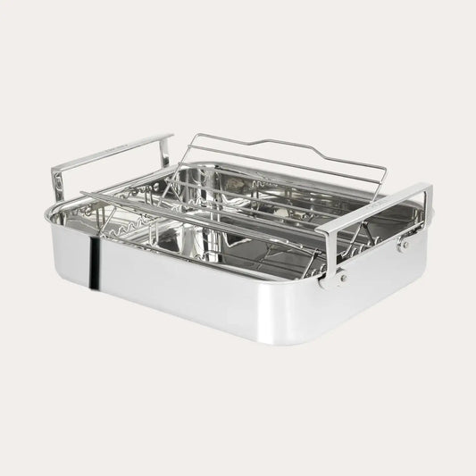 Stainless steel roasting pan with rack on a white background