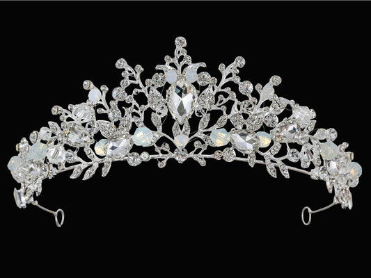 Silver tiara with intricate design on a black background