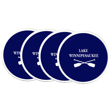 Set of four blue coasters with 'Lake Winnipesaukee' and paddle design on a white background