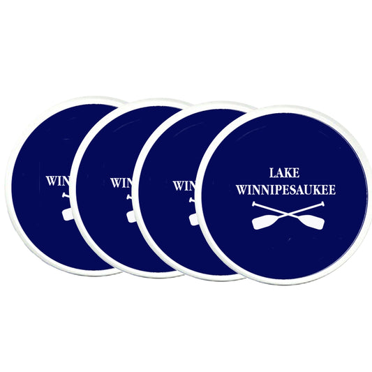 Set of four blue coasters with 'Lake Winnipesaukee' and paddle design on a white background
