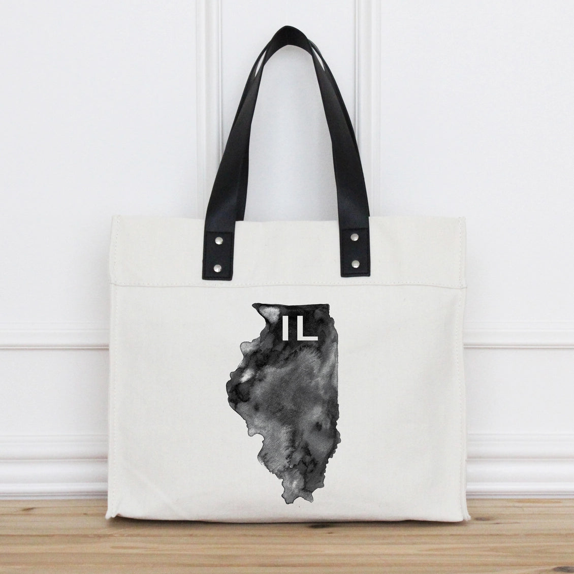 Tote bag with black handle and Illinois state outline design on a white background