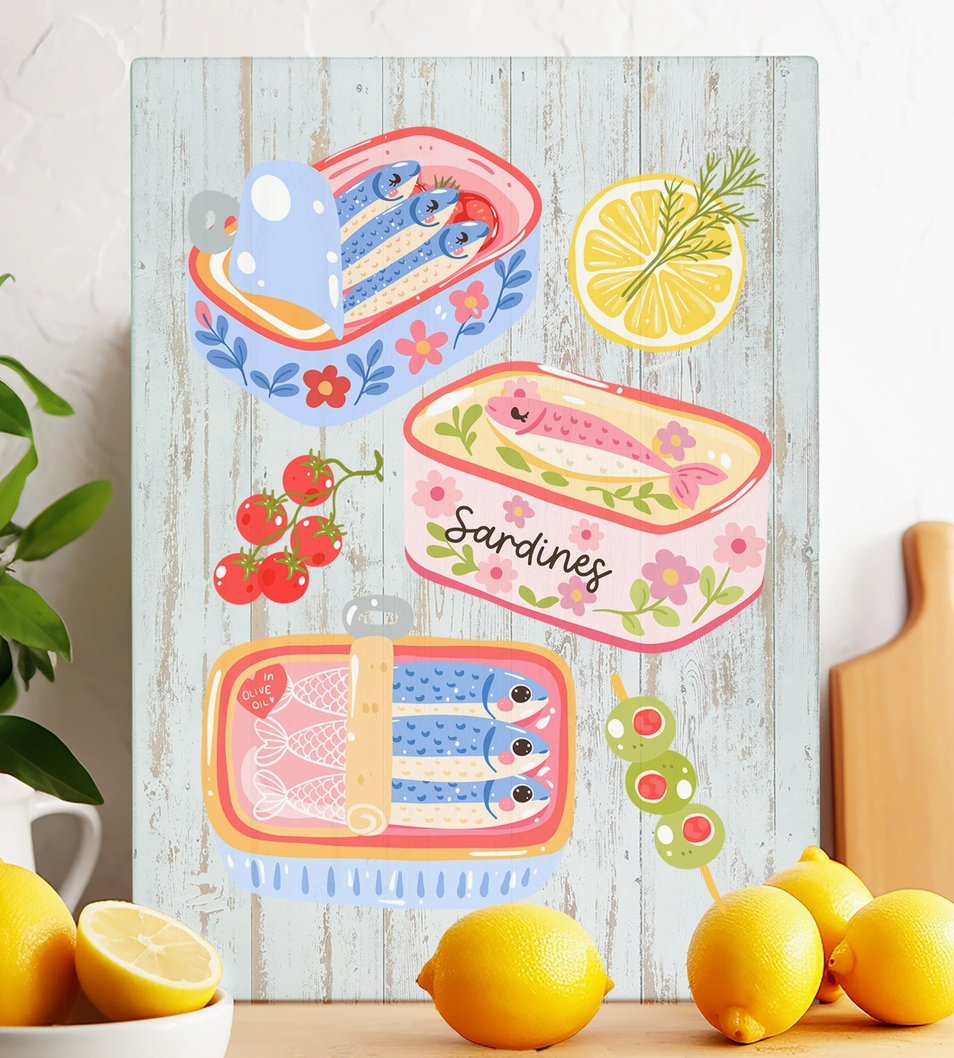 Colorful sardine tin glass trivet featuring illustrated fish tins with lemon tomatoes and olives in a coastal design