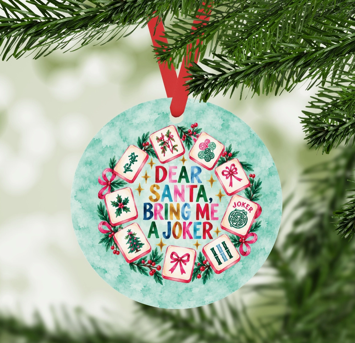 Dear Santa Bring Me a Joker Mahjong ornament hanging from Christmas tree with red ribbon