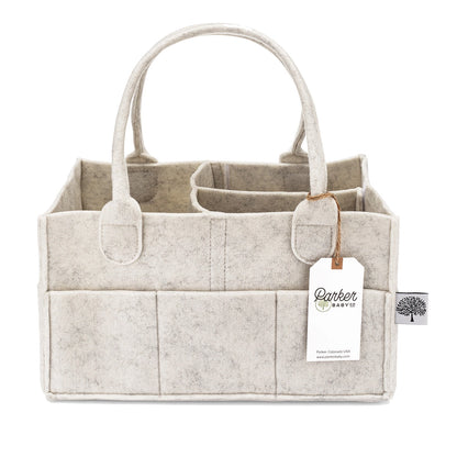 Beige felt caddy with handles and a tag on a white background