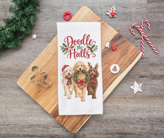 Doodle the Halls Christmas kitchen towel featuring three doodle dogs dressed in festive holiday accessories