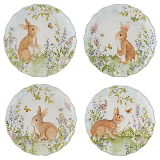 Four round coasters with rabbit and floral designs on a white background