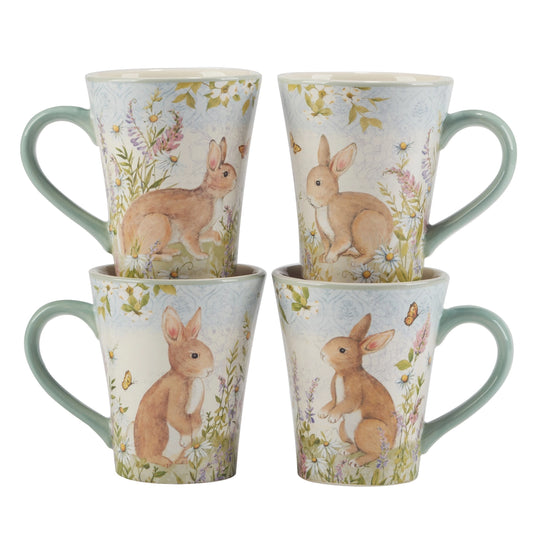 Set of four mugs with rabbit and floral design on a white background