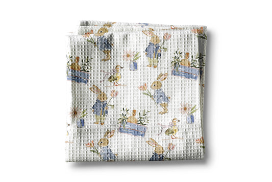 Waffle-textured blanket with cartoon rabbit design on a white background