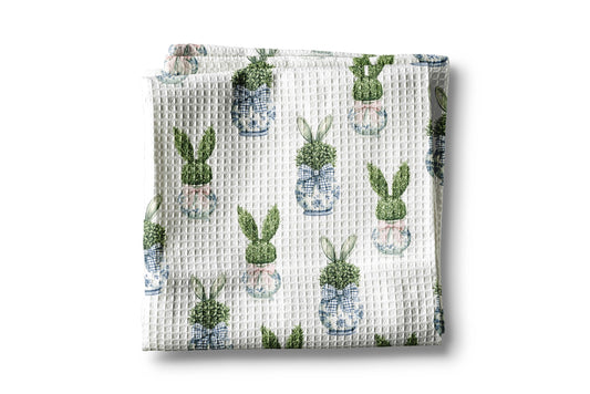 Waffle-textured blanket with cactus pattern on a white background