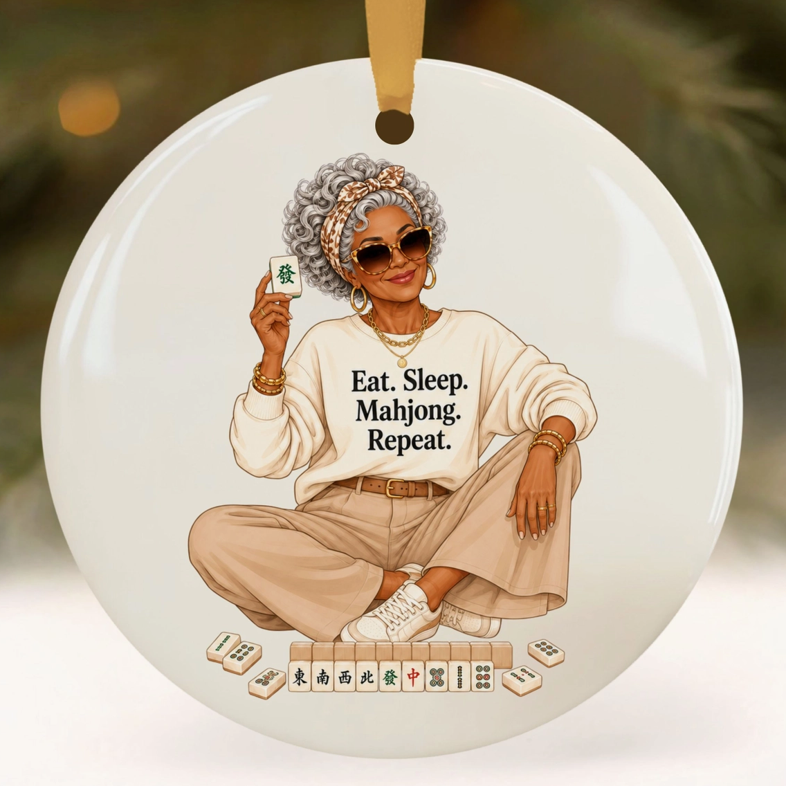 Eat Sleep Mahjong Repeat ceramic ornament featuring stylish silver-haired woman holding a Mahjong tile with game tiles at her feet.