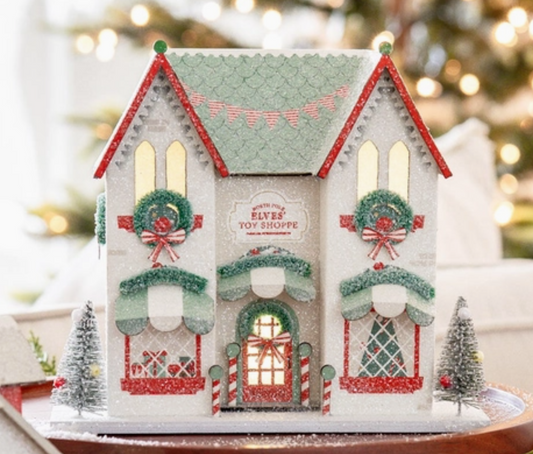 Decorative Christmas house with lights on a blurred festive background