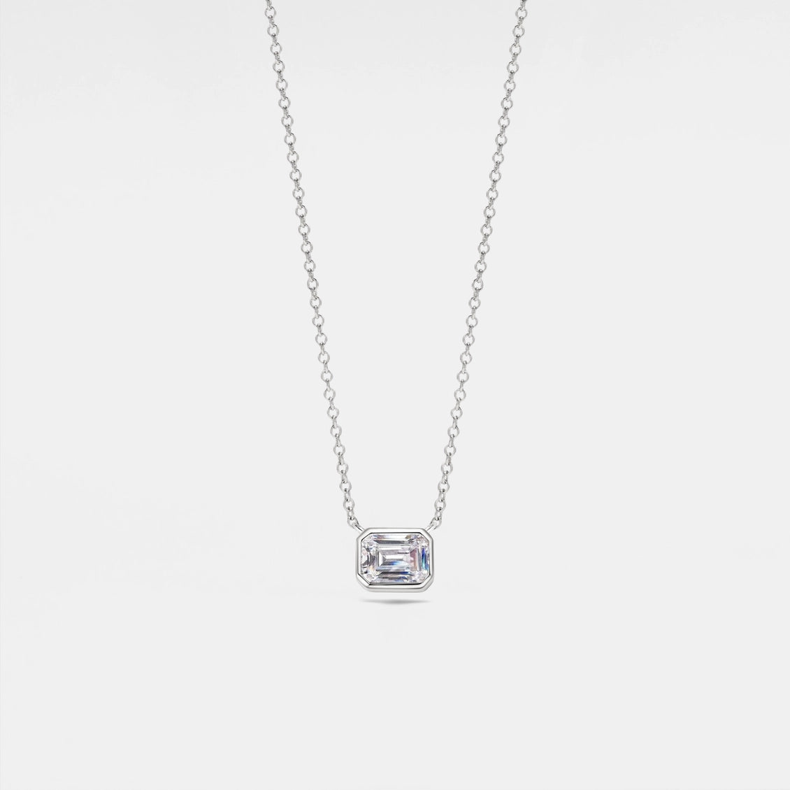 Diamond necklace with a rectangular pendant on a light gray background