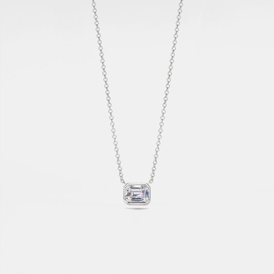 Diamond necklace with a rectangular pendant on a light gray background
