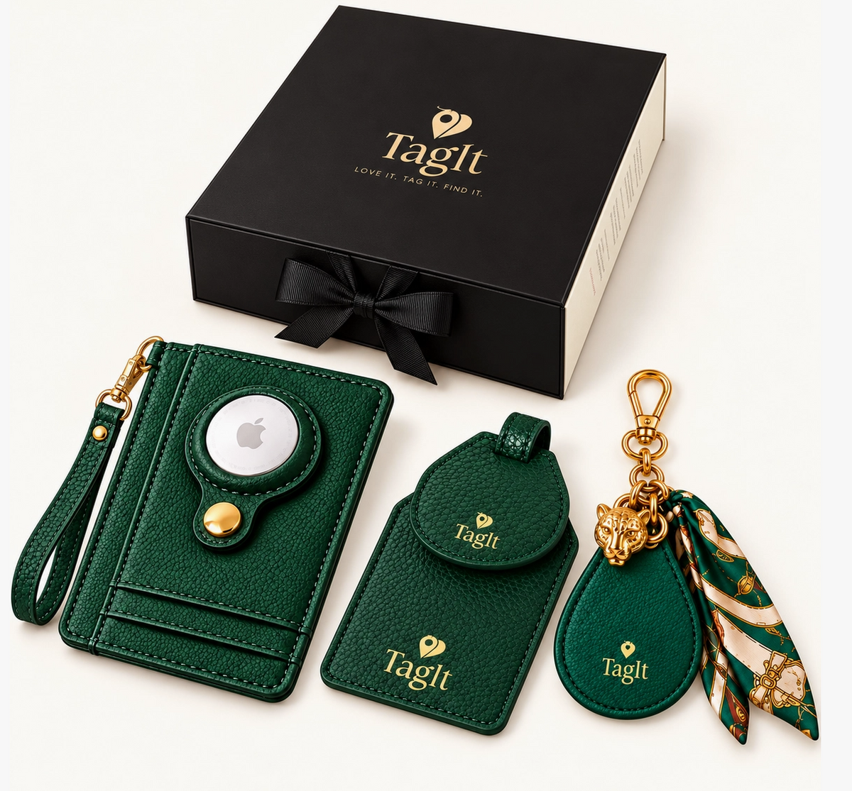 Emerald green wallet with wristlet, matching luggage tag, and leopard charm scarf keychain displayed beside a black gift box.