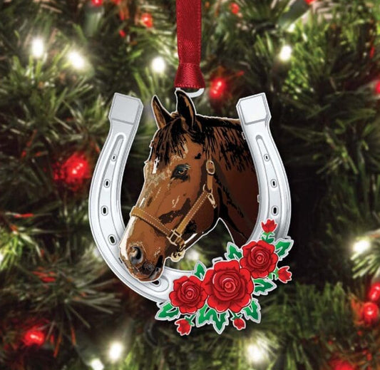 Decorative Christmas ornament with a horse head and horseshoe design on a tree.