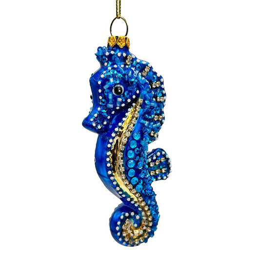 Decorative blue seahorse ornament with gold accents on a white background