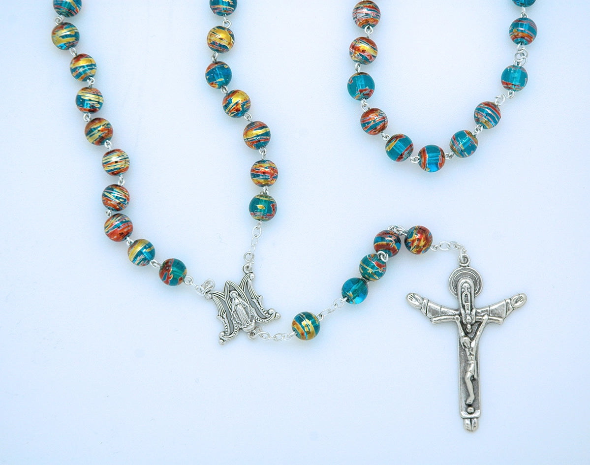 Colorful beaded rosary with silver crucifix and Marian medal on a white background
