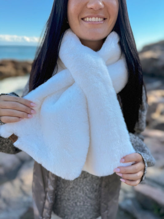 Person wearing a white scarf with a blurred natural background