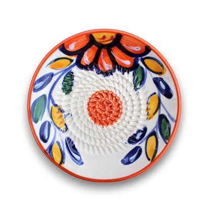 A round white ceramic bowl with a textured, ribbed interior and hand-painted traditional Mexican Talavera style floral patterns in orange, blue, yellow, and green, shown on a white background with a soft drop shadow.