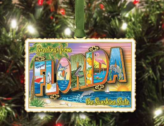 Decorative ornament with 'Greetings from Florida' text on a Christmas tree.