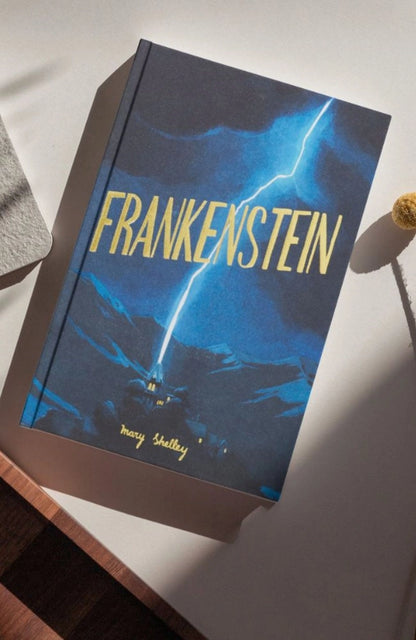 Book titled 'Frankenstein' by Mary Shelley on a white surface