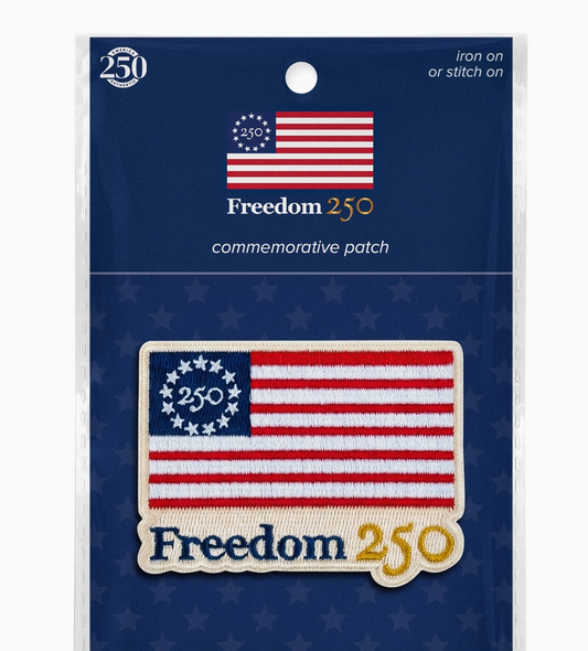 Freedom 250 commemorative patch on a blue background with American flag design.
