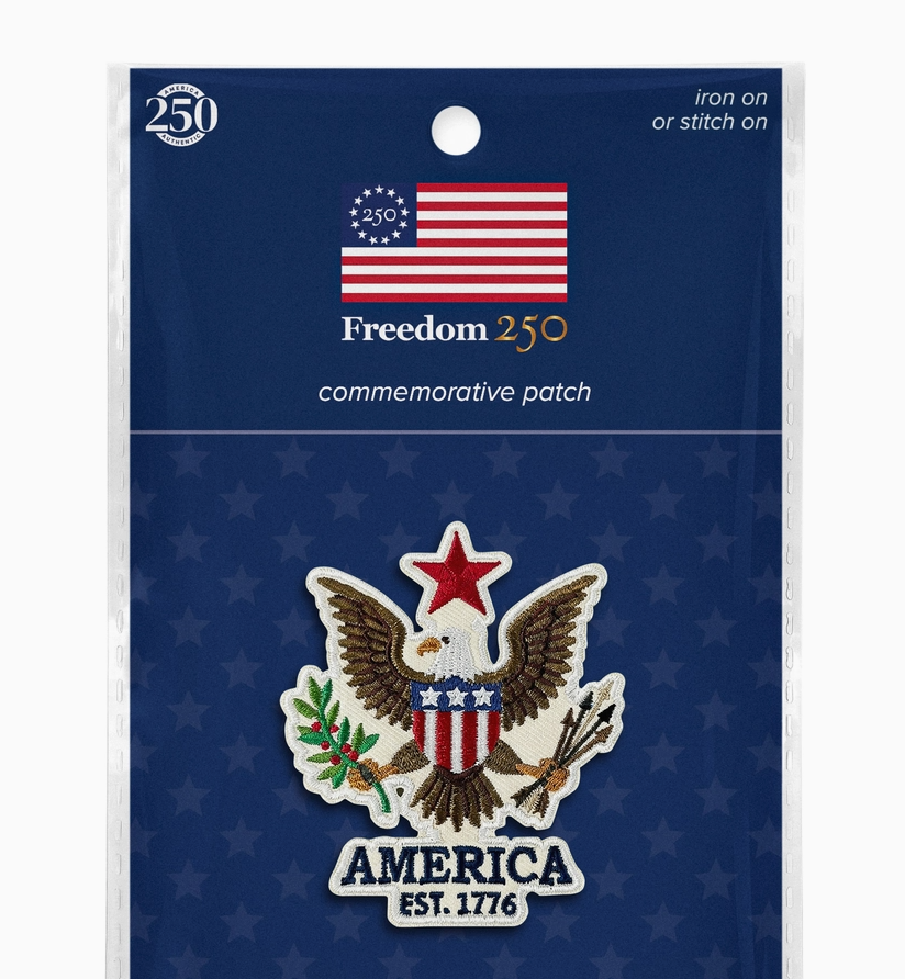 Packaged commemorative patch with American flag and eagle design on a blue background.