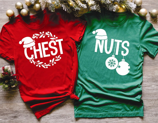 Red and green t-shirts with Christmas-themed text and graphics on a wooden surface.