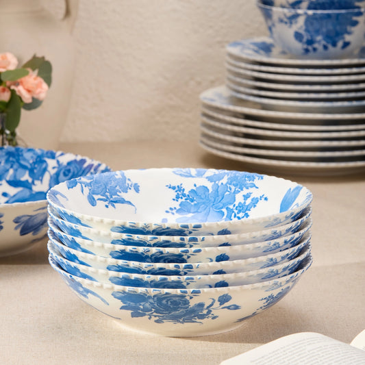 Stack of blue floral-patterned ceramic bowls on a neutral surface.