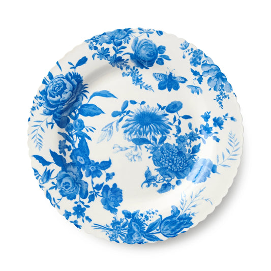 White plate with blue floral and butterfly design on a white background