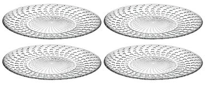 Four clear glass plates with textured design on a white background