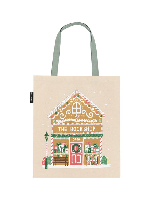 Tote bag with a gingerbread house design labeled 'The Bookshop' on a beige background