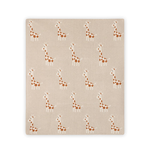 A square fabric item, likely a blanket or throw, featuring a repeating pattern of cartoon giraffes in brown and white on a warm beige background.